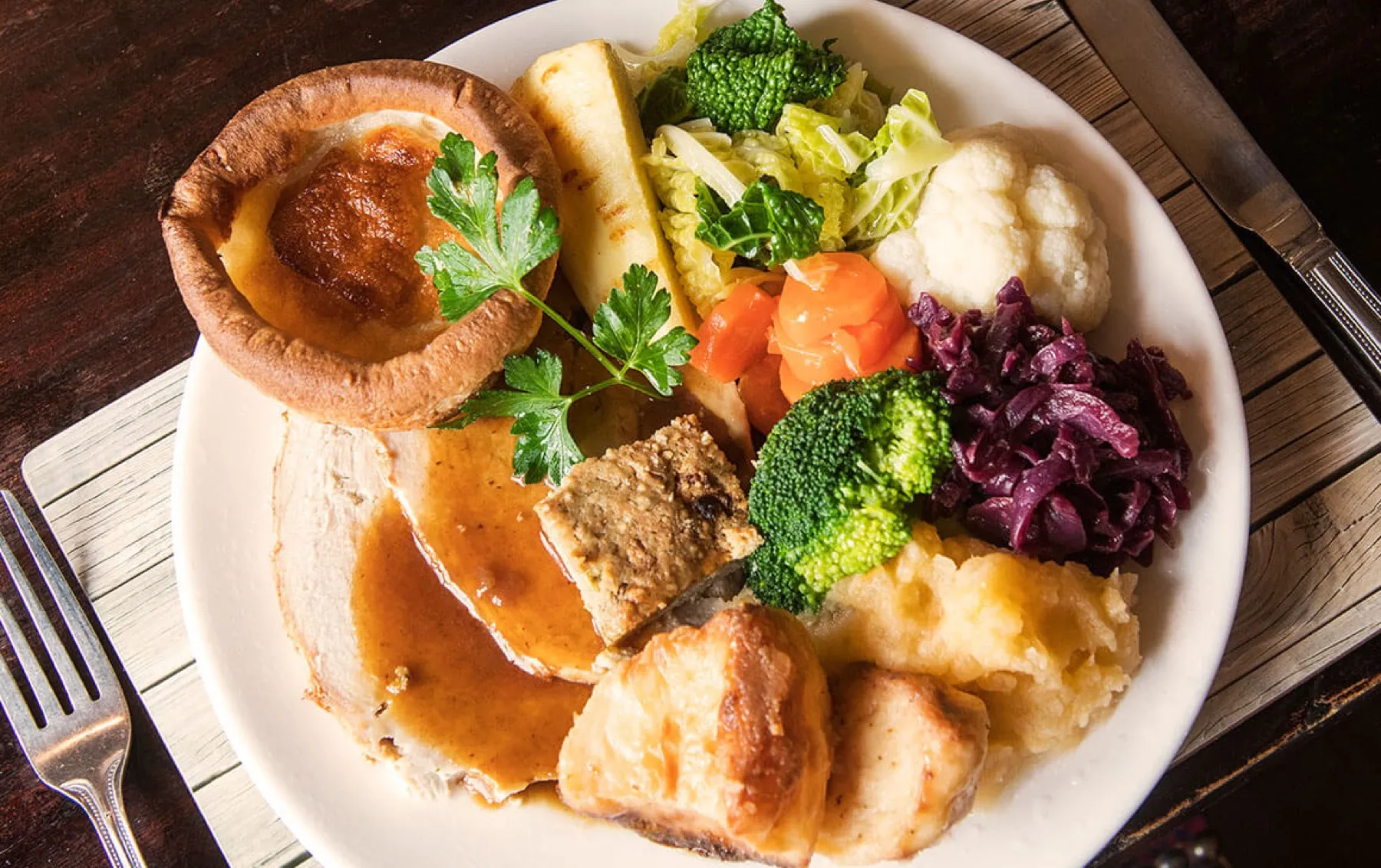 A Stags Head carvery plate with Yorkshire pudding, roast potatoes, stuffing and seasonal vegetables