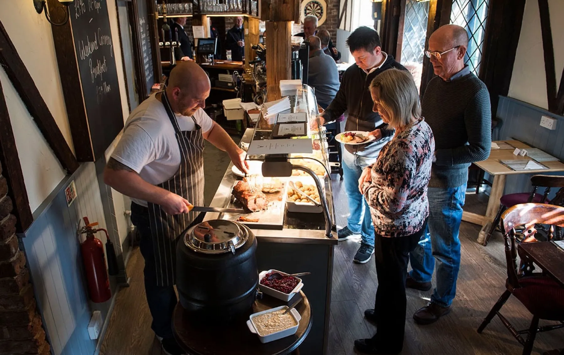The chef carving at the Sunday carvery deck while guests queue